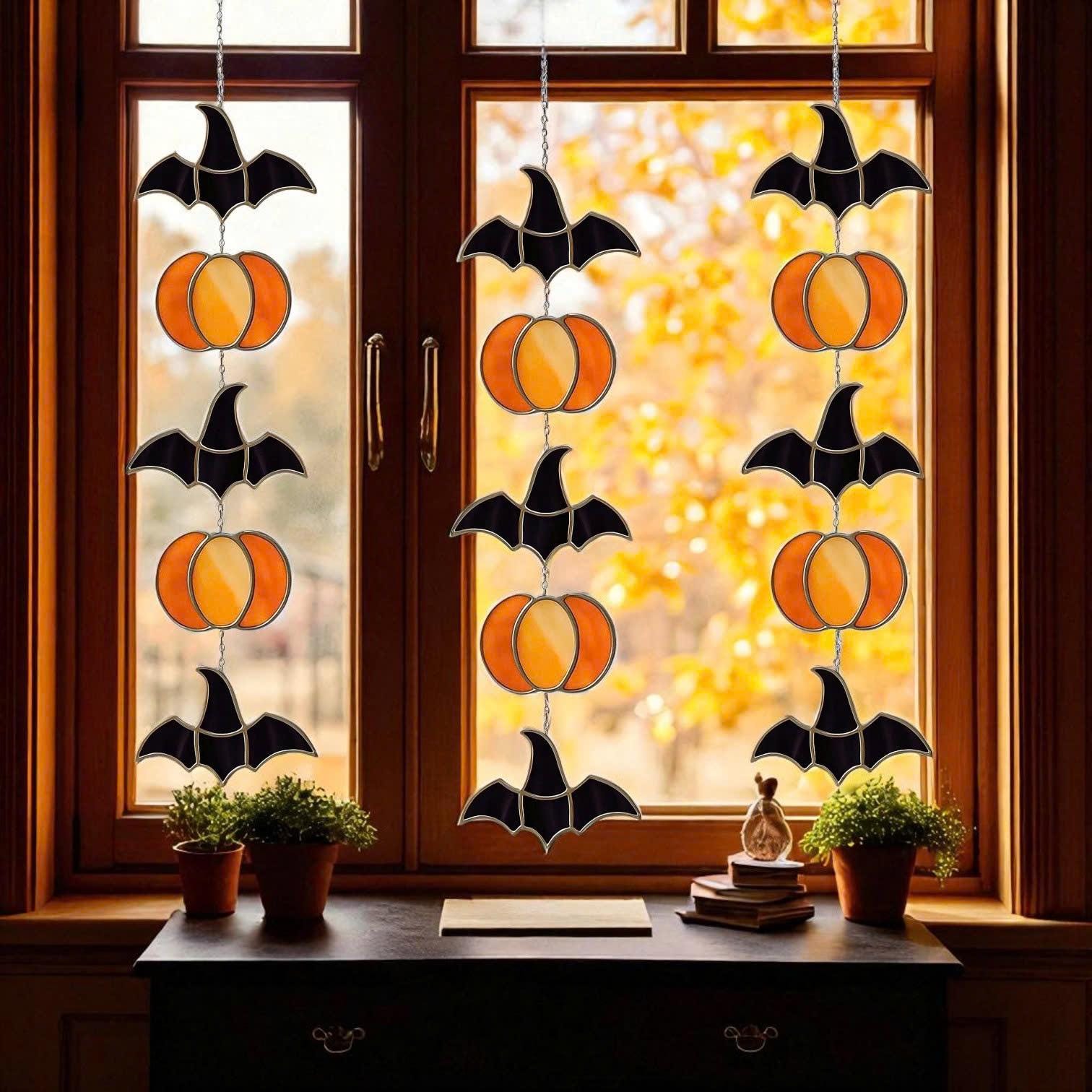 Handmade stained glass Halloween suncatcher featuring cute ghosts with witch hats and orange pumpkins, window hanging decoration