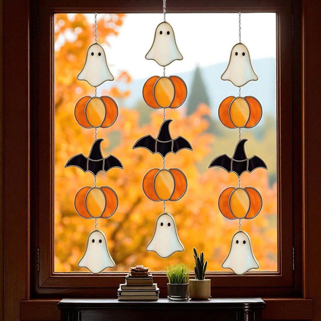 Handmade stained glass Halloween suncatcher featuring cute ghosts with witch hats and orange pumpkins, window hanging decoration