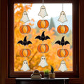 Handmade stained glass Halloween suncatcher featuring cute ghosts with witch hats and orange pumpkins, window hanging decoration
