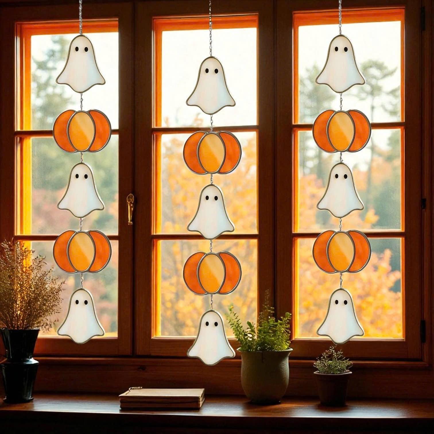 Handmade stained glass Halloween suncatcher featuring cute ghosts with witch hats and orange pumpkins, window hanging decoration