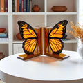 Handmade stained glass butterfly bookends with oak wood base, unique orange monarch wing design, decorative bookshelf decor and gift for book lovers.
