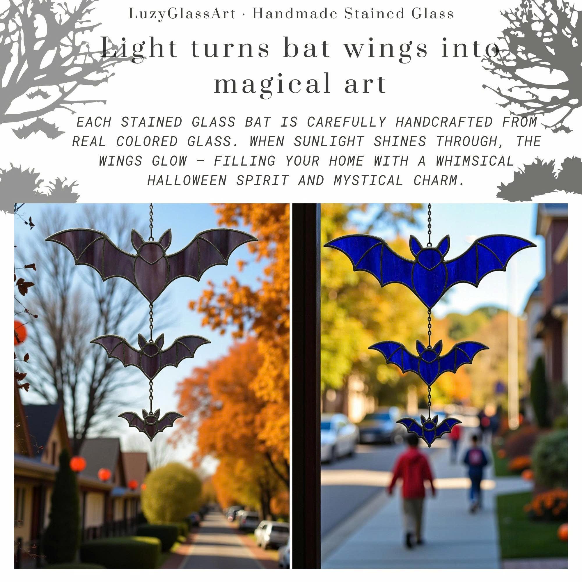 Whimsical stained glass bat window hanging with autumn background – handcrafted Halloween decoration.