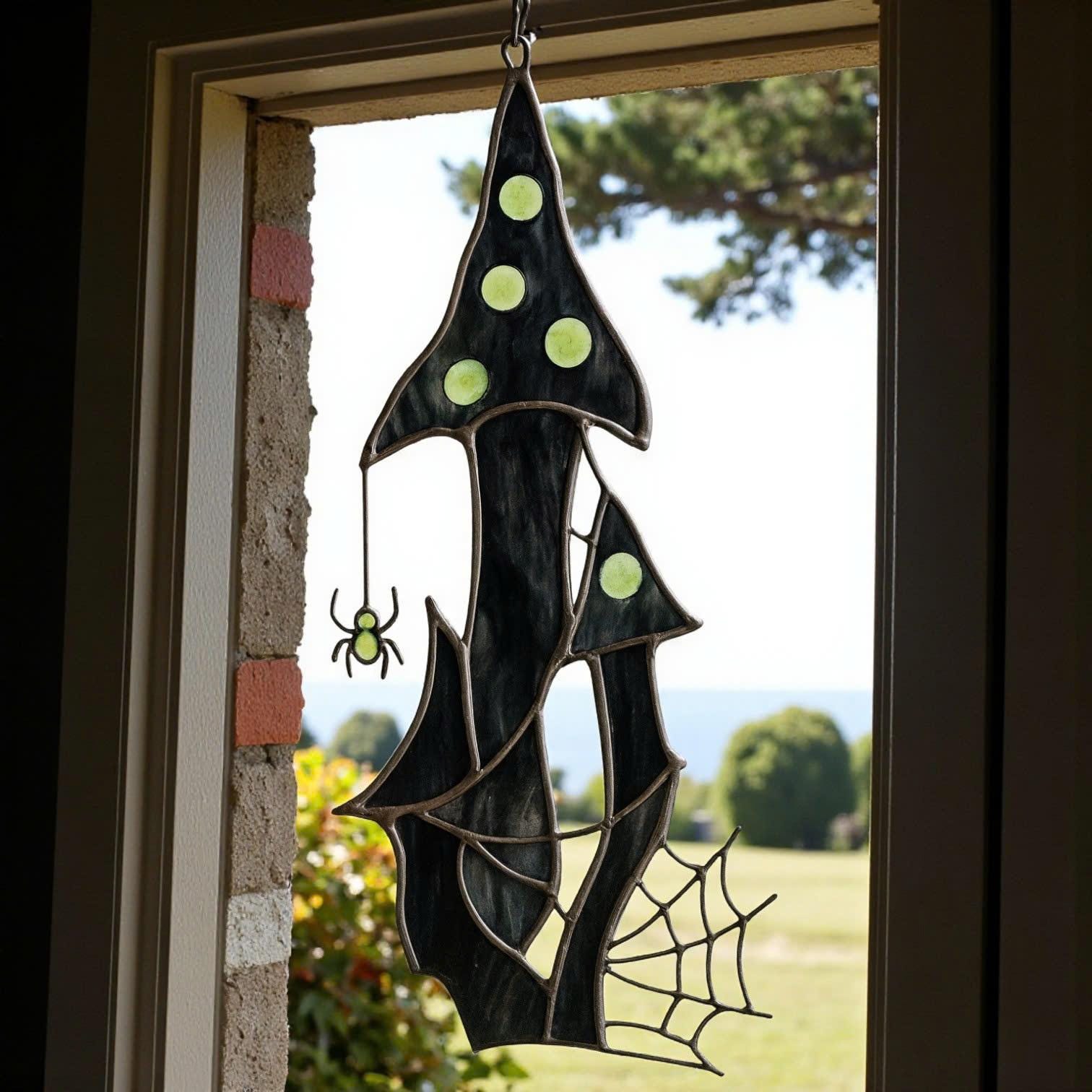 Spooky stained glass suncatcher with crescent moon and gothic haunted house