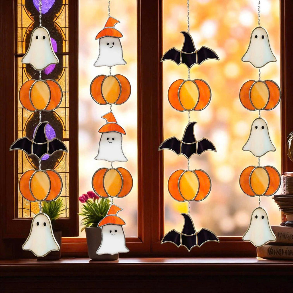 Handmade stained glass Halloween suncatcher featuring cute ghosts with witch hats and orange pumpkins, window hanging decoration