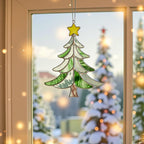 Stained glass Christmas tree suncatcher (Style #1) hanging indoors, showing the clear dark green and white glass design.