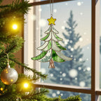 Stained glass tree ornament (Style #3) hanging in a window at night, with warm yellow Christmas light bokeh.