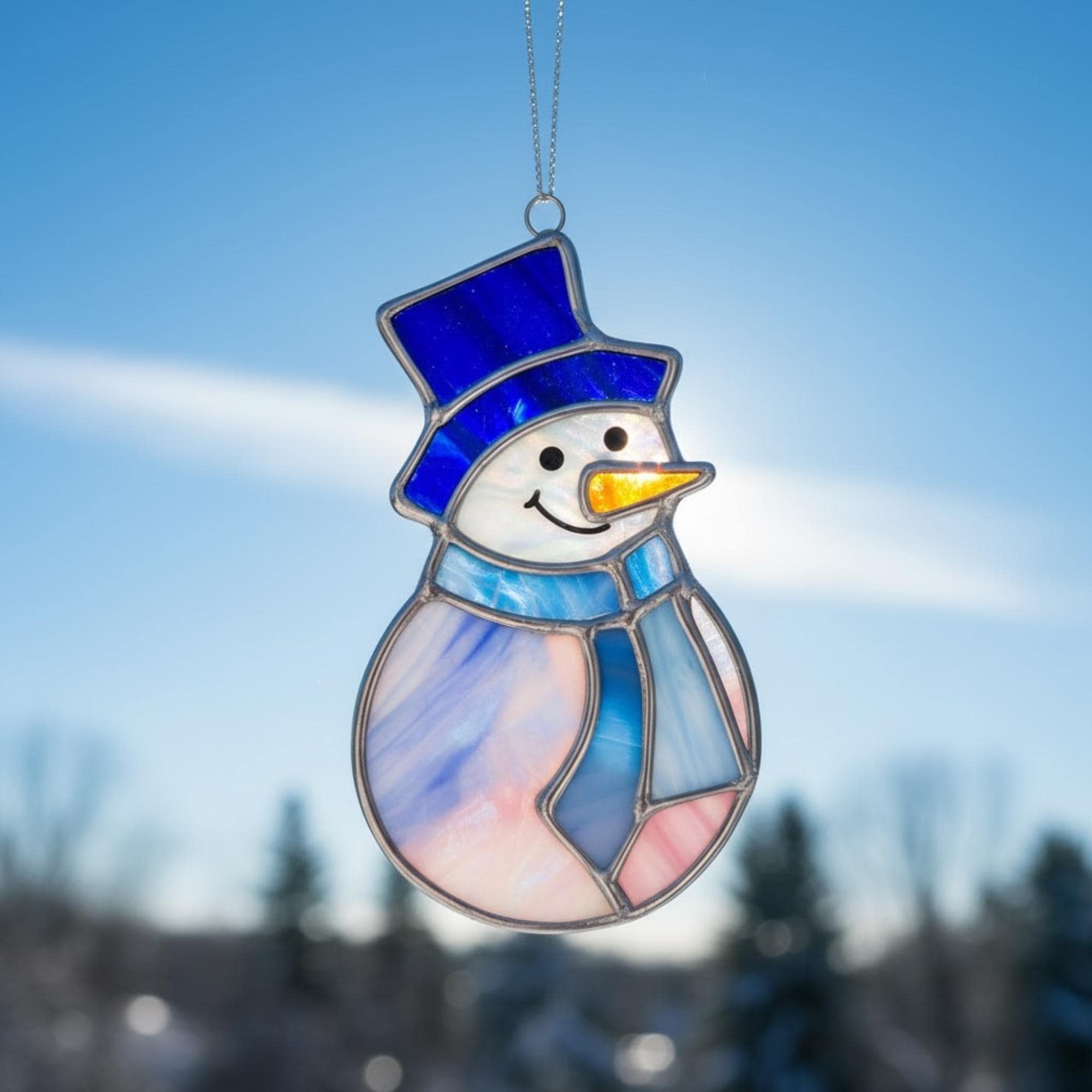 Close-up of the stained glass snowman (Style #1) standing upright in deep, fluffy snow.