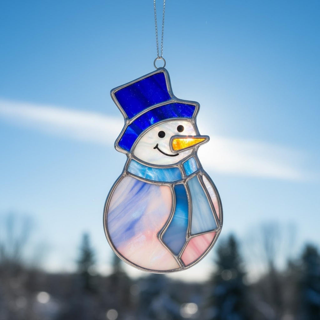 Close-up of the stained glass snowman (Style #1) standing upright in deep, fluffy snow.
