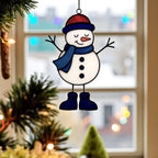 Stained glass snowman (Style #1, blue hat) hanging against a bright blue sky, showing the glass translucency and wispy colors.