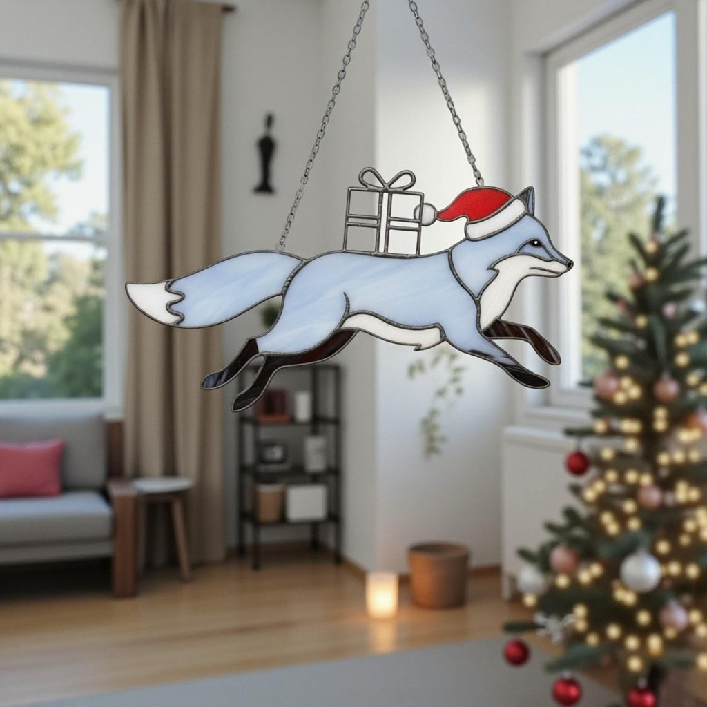 Blue fox stained glass suncatcher with gift box in winter window scene.