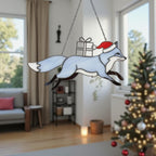 Blue fox stained glass suncatcher with gift box in winter window scene.