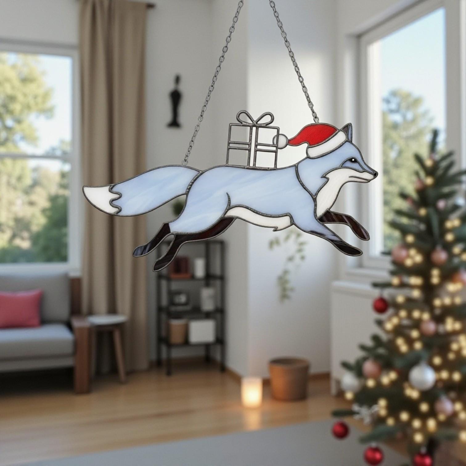 Blue fox stained glass suncatcher with gift box in winter window scene.