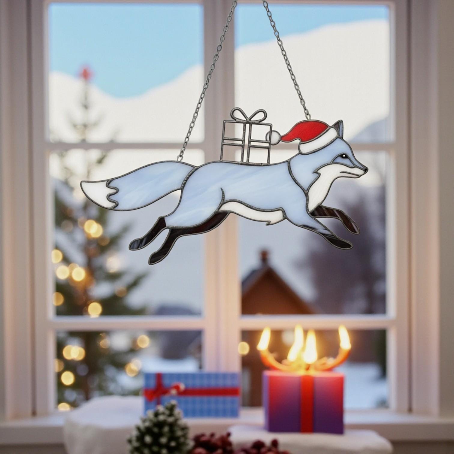 Handmade stained glass fox ornament displayed with Christmas tree background.