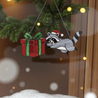 Handmade raccoon glass suncatcher under pine branches with Christmas lights.