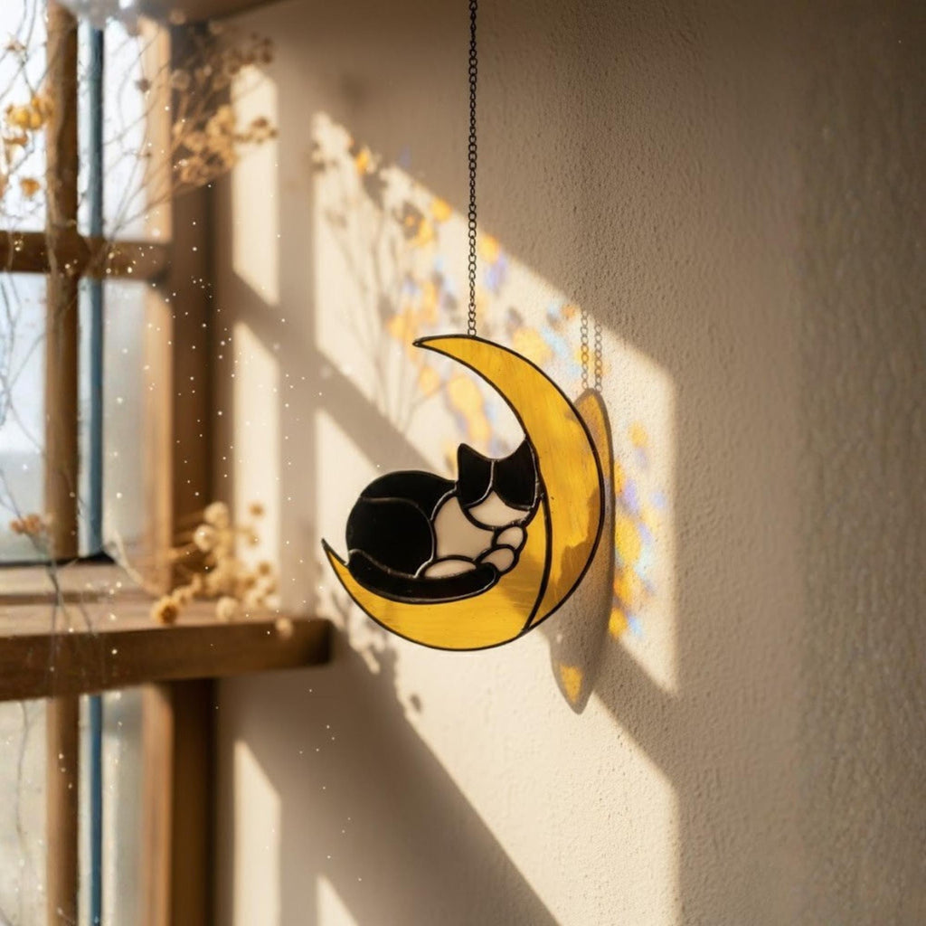 Stained glass cat on the moon suncatcher hanging in sunny window, handmade celestial home decor