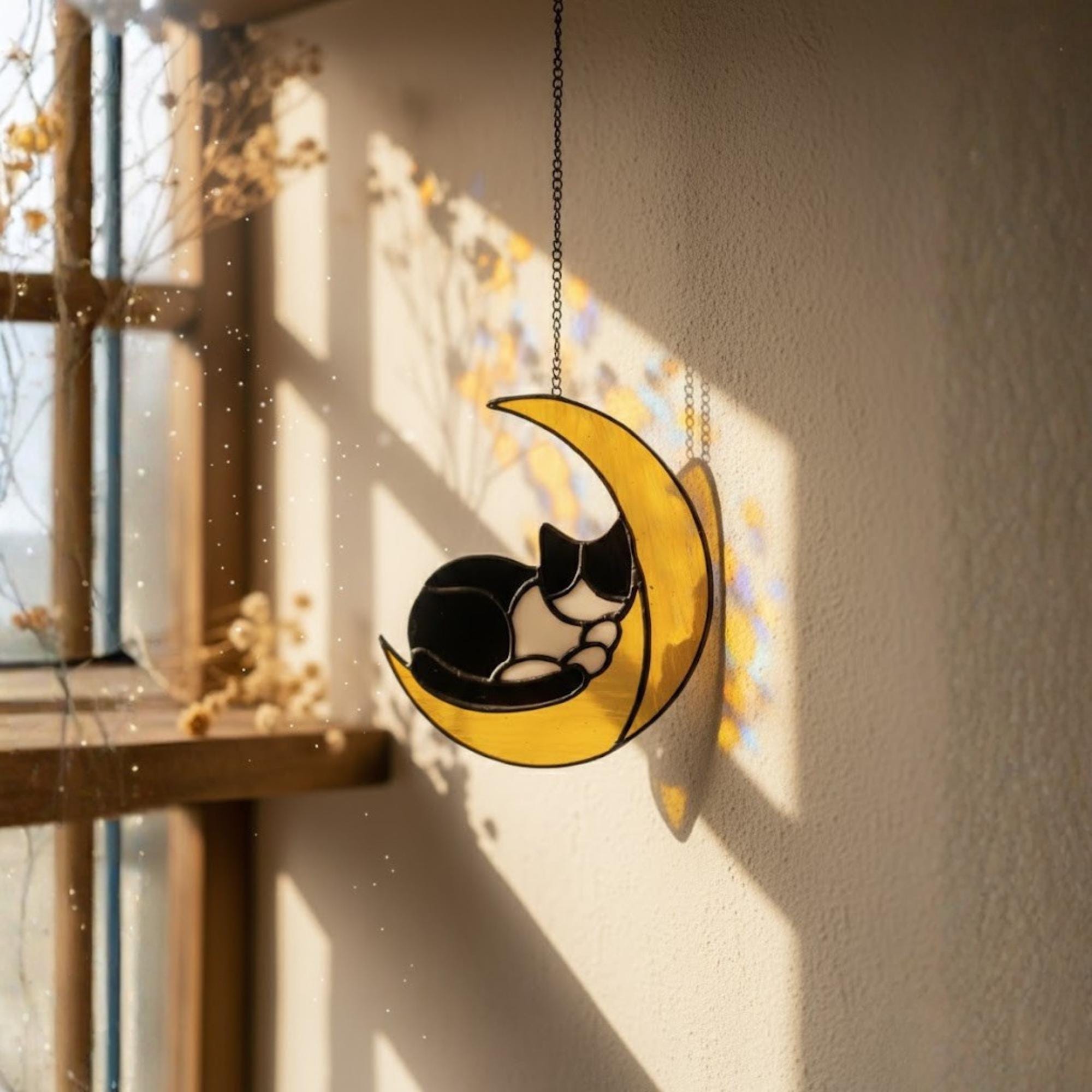 Stained glass cat on the moon suncatcher hanging in sunny window, handmade celestial home decor