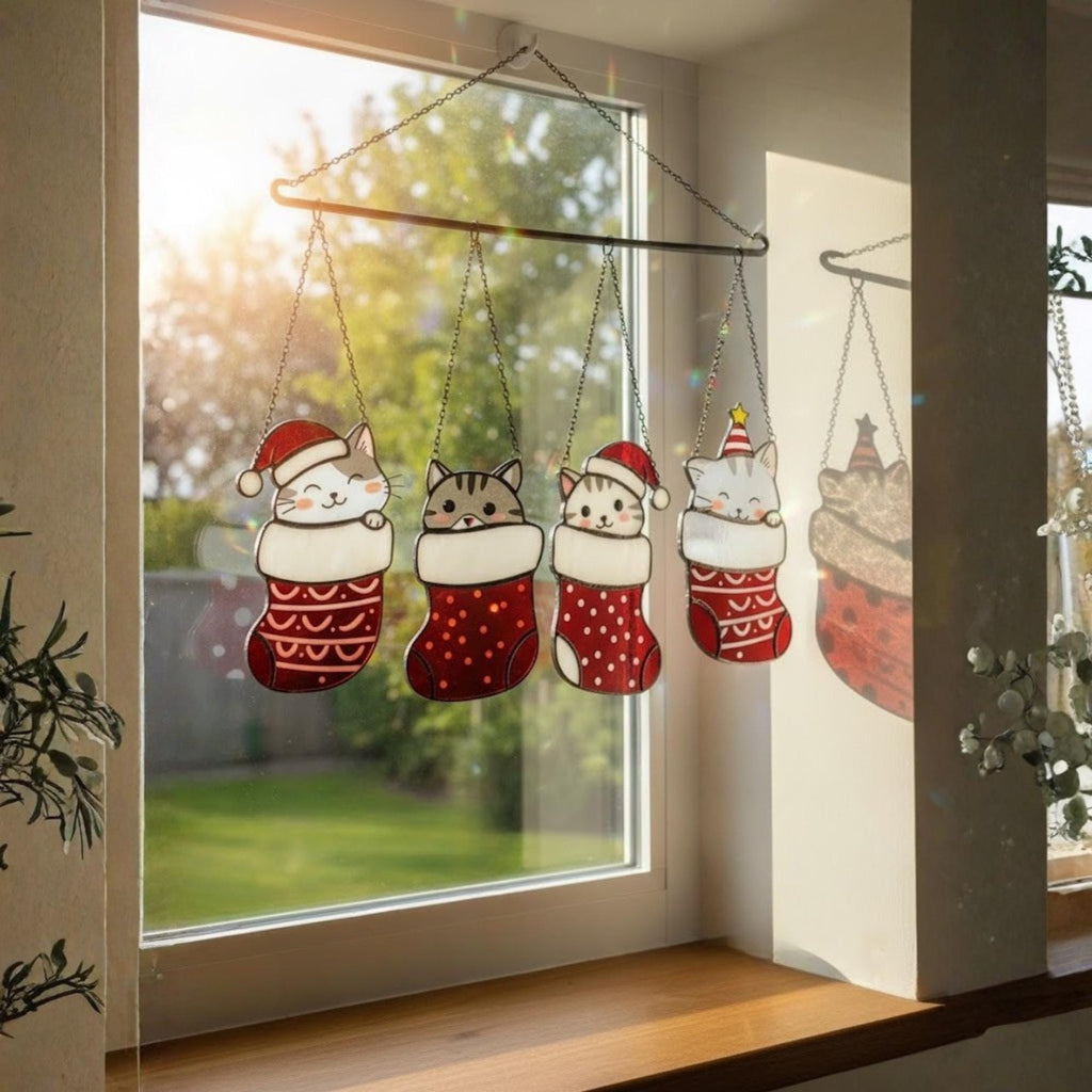 Christmas cat stained glass suncatcher hanging on window, handmade holiday ornament glowing in sunlight.