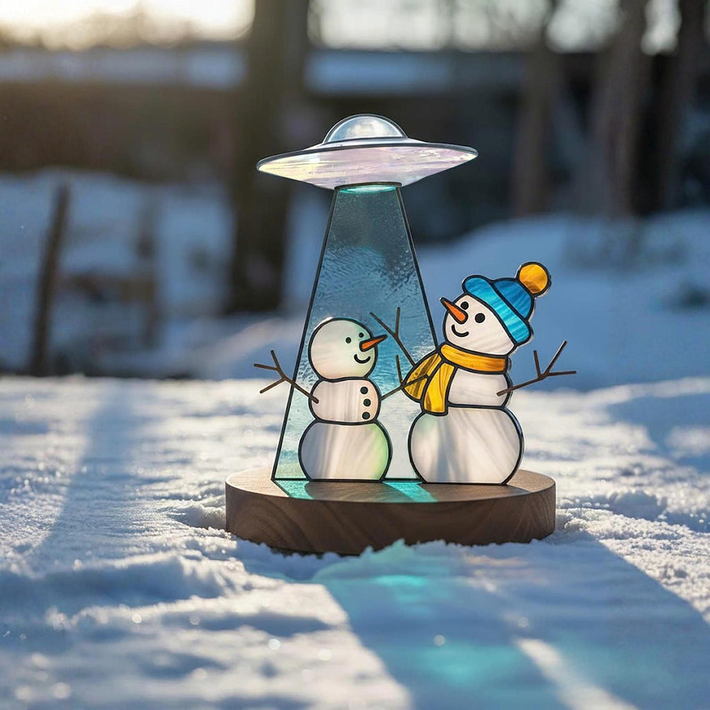Handmade glass snowman ornament glowing in sunlight – Christmas holiday home decor gift.