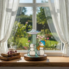 Handmade glass snowman decor surrounded by lights – Christmas home inspiration.