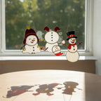 Christmas stained glass snowman set displayed on windowsill – festive holiday vibe.
