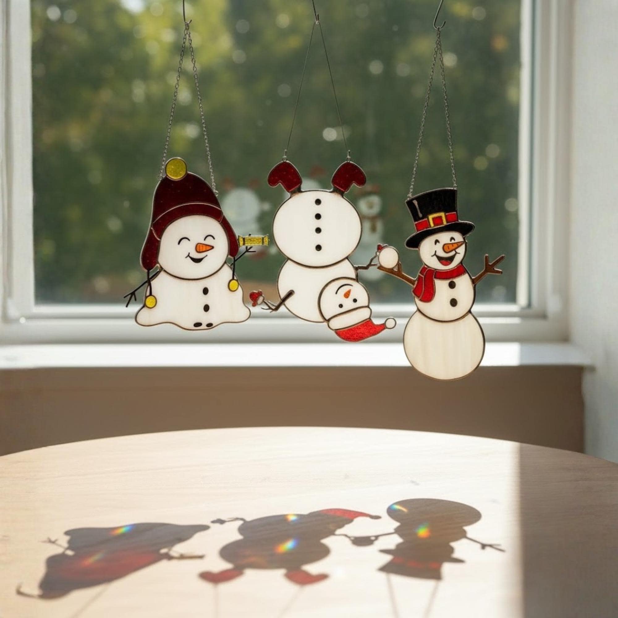 Christmas stained glass snowman set displayed on windowsill – festive holiday vibe.