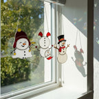Woman hanging stained glass snowman ornament by window – holiday home decoration.