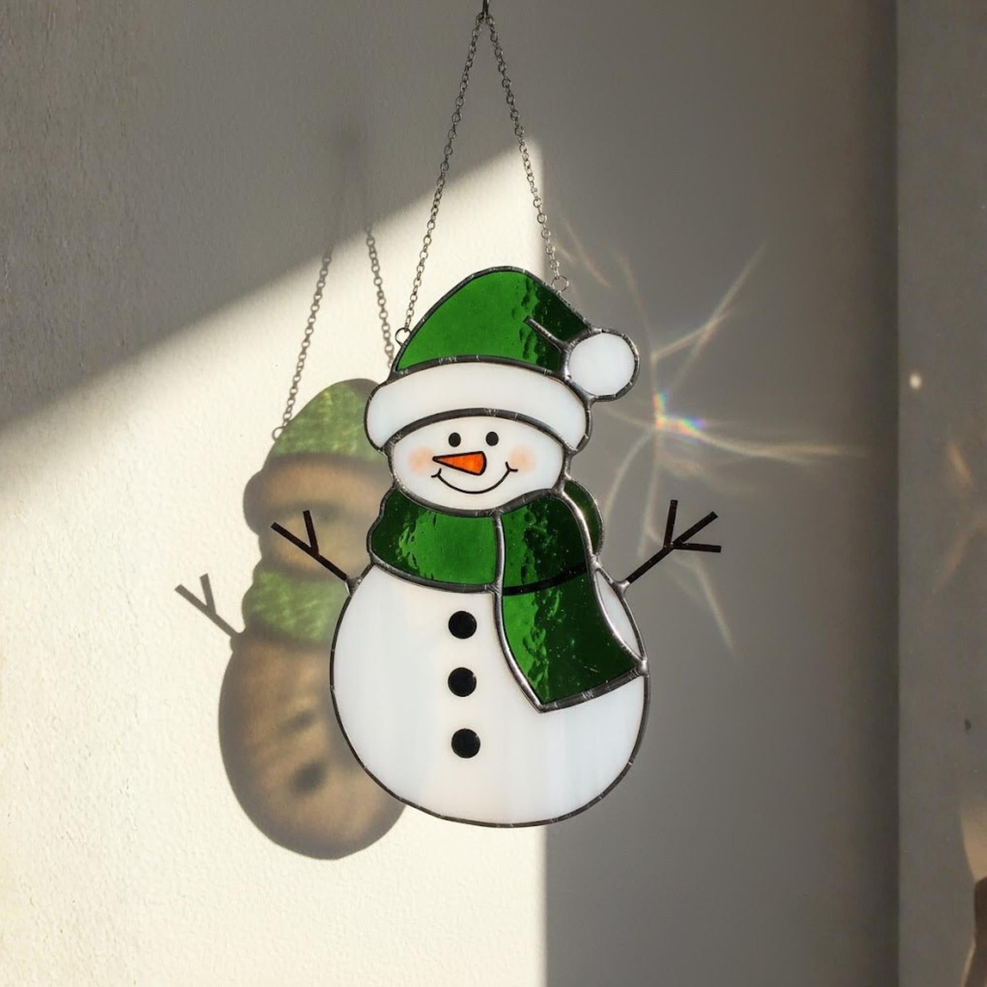 Cute handmade snowman glass ornament with green hat – unique holiday decor gift.