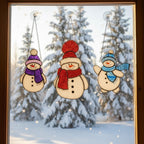 Pair of snowman stained glass ornaments in sunlight – perfect handmade holiday decor.