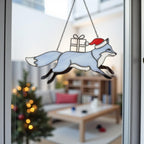 Snowman stained glass tree ornament hanging under holiday lights, handmade Christmas decor.