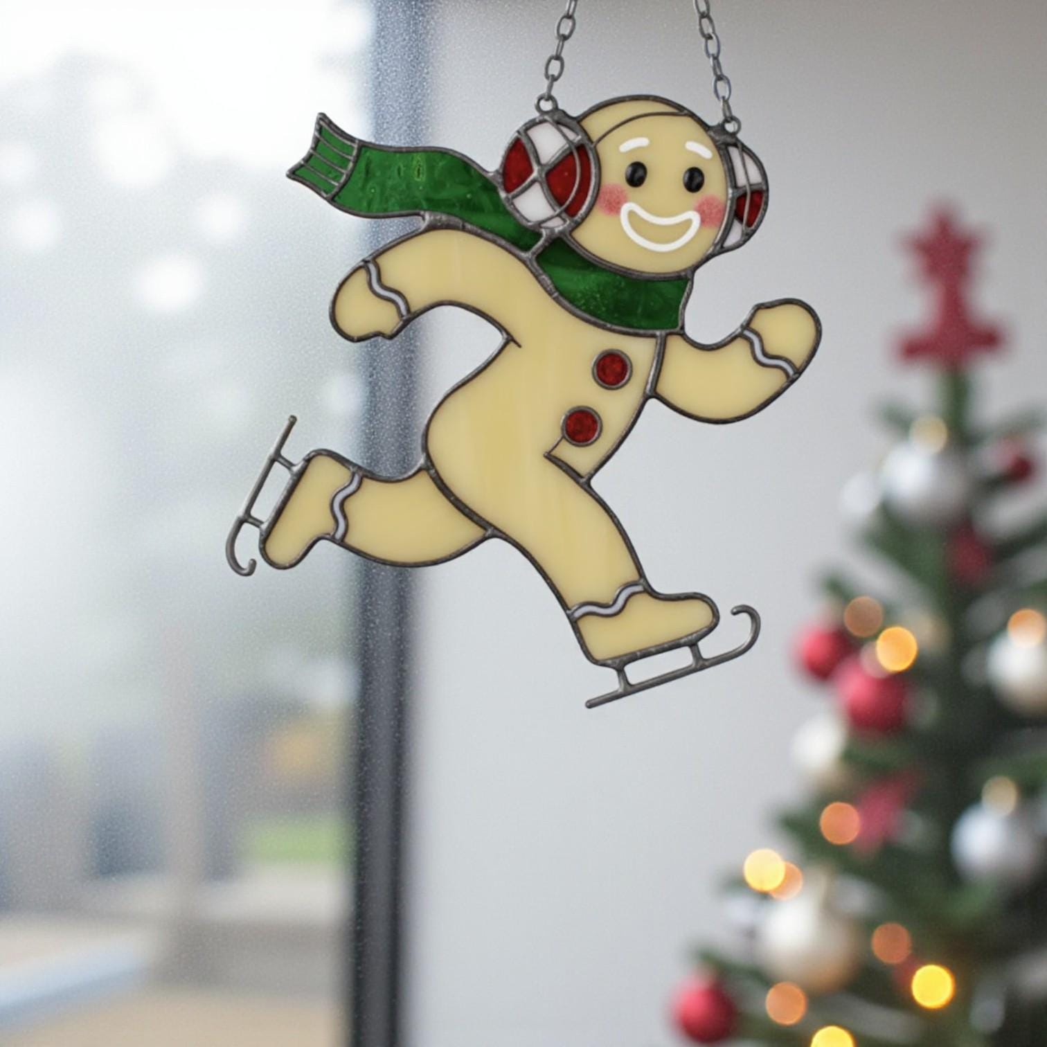 Gingerbread stained glass art with green scarf and earmuffs, window holiday decoration.