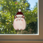 Gray tabby cat stained glass ornament casting soft light shadow – holiday home accent.