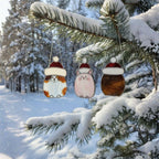 Cat ornament hanging on window surrounded by green garden – all-season decor.