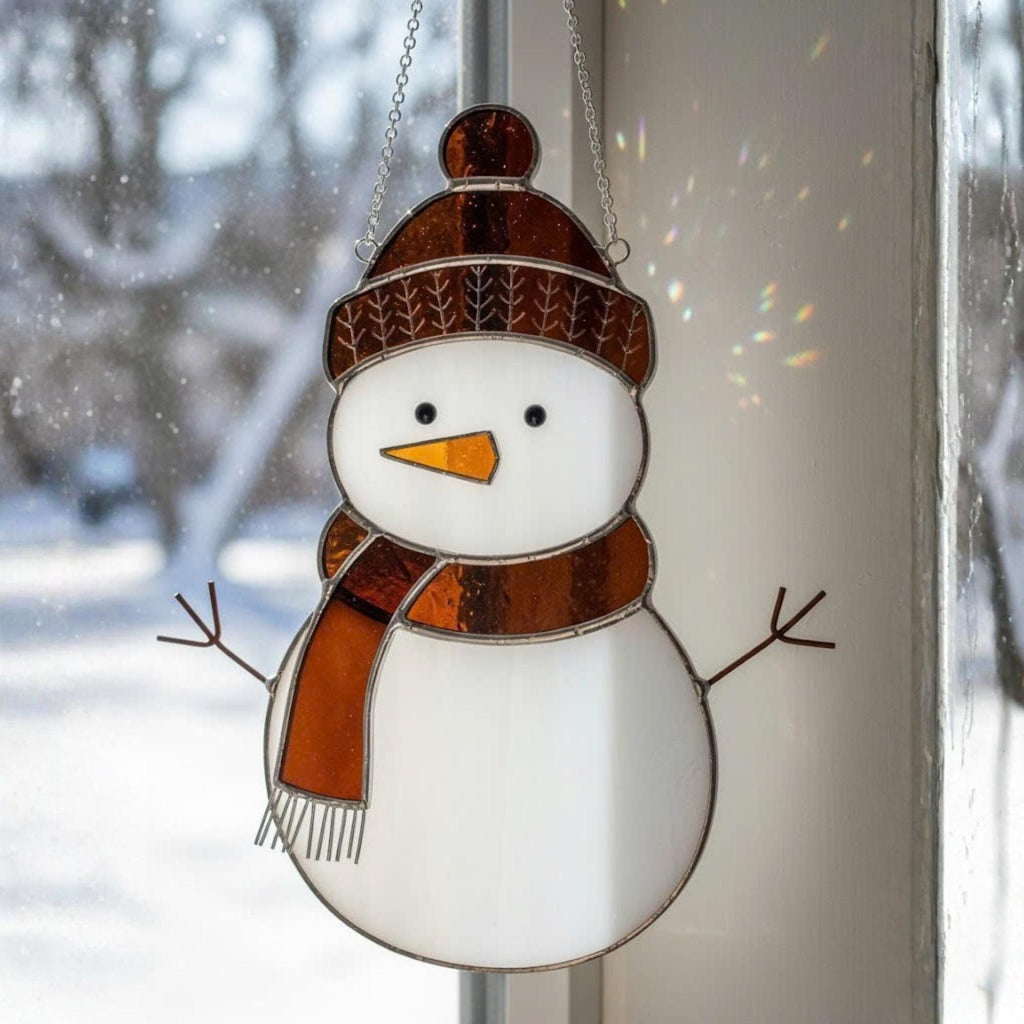 Brown hat snowman ornament glowing in sunlight – handmade stained glass gift for winter.
