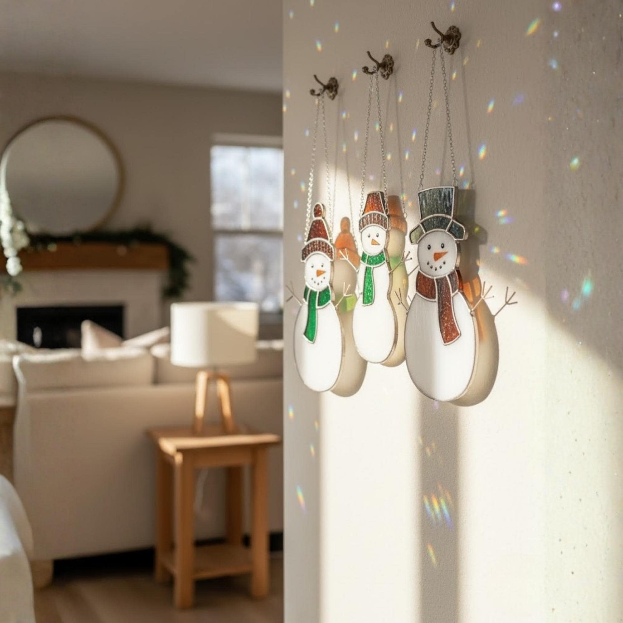 Trio of snowmen stained glass ornaments shining on window – Christmas window art decor.