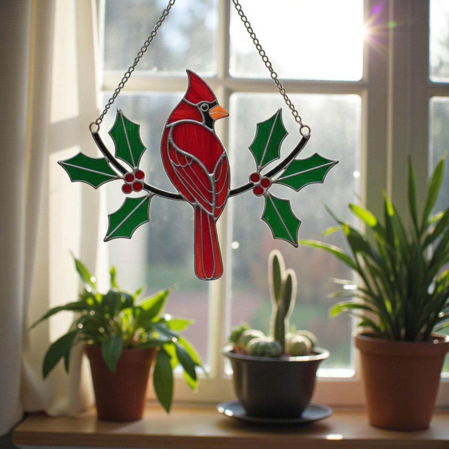 Red glass bird with green leaves – handmade stained glass ornament for holiday home decoration.