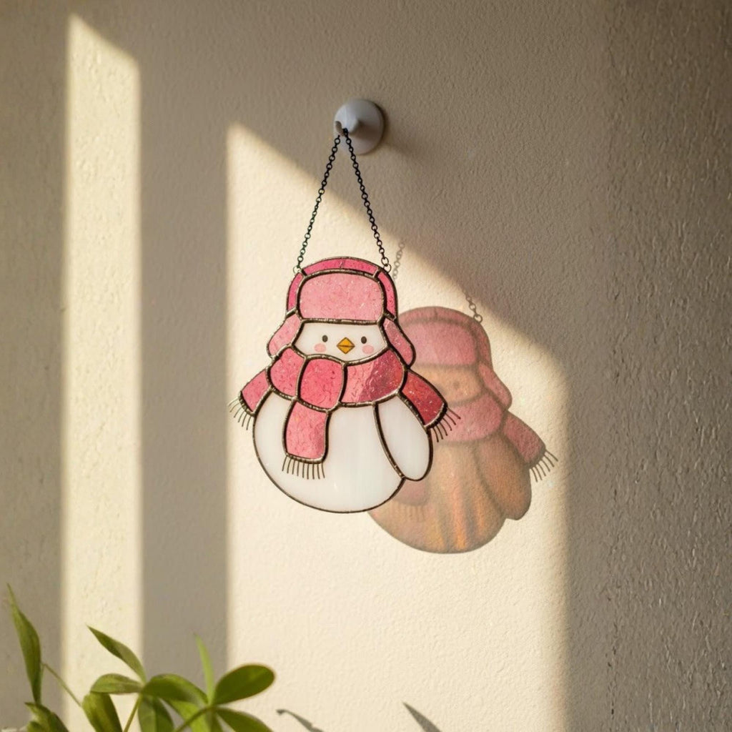 Pink bird ornament glowing in light – handmade Christmas suncatcher decoration.