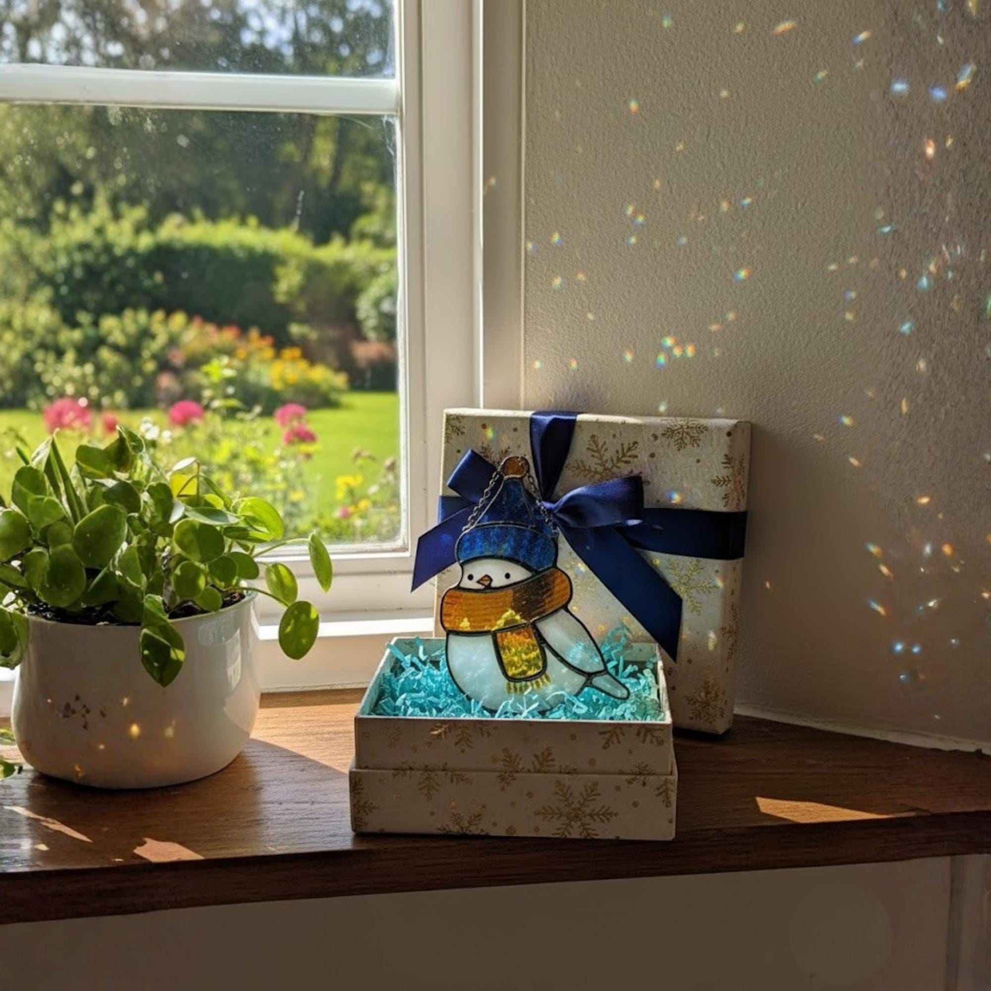 Handmade glass bird ornaments reflecting sunlight – colorful suncatcher for window decor.