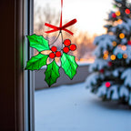 Winter home decoration – stained glass holly ornament sparkling in natural light.