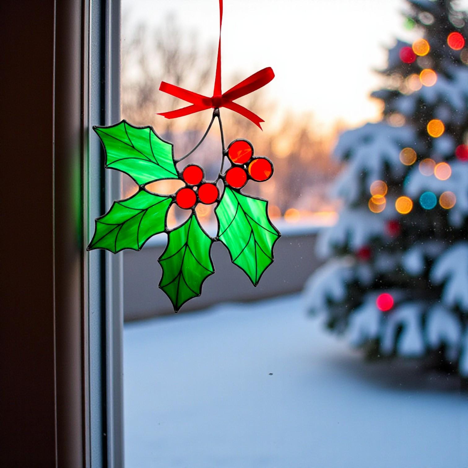 Winter home decoration – stained glass holly ornament sparkling in natural light.