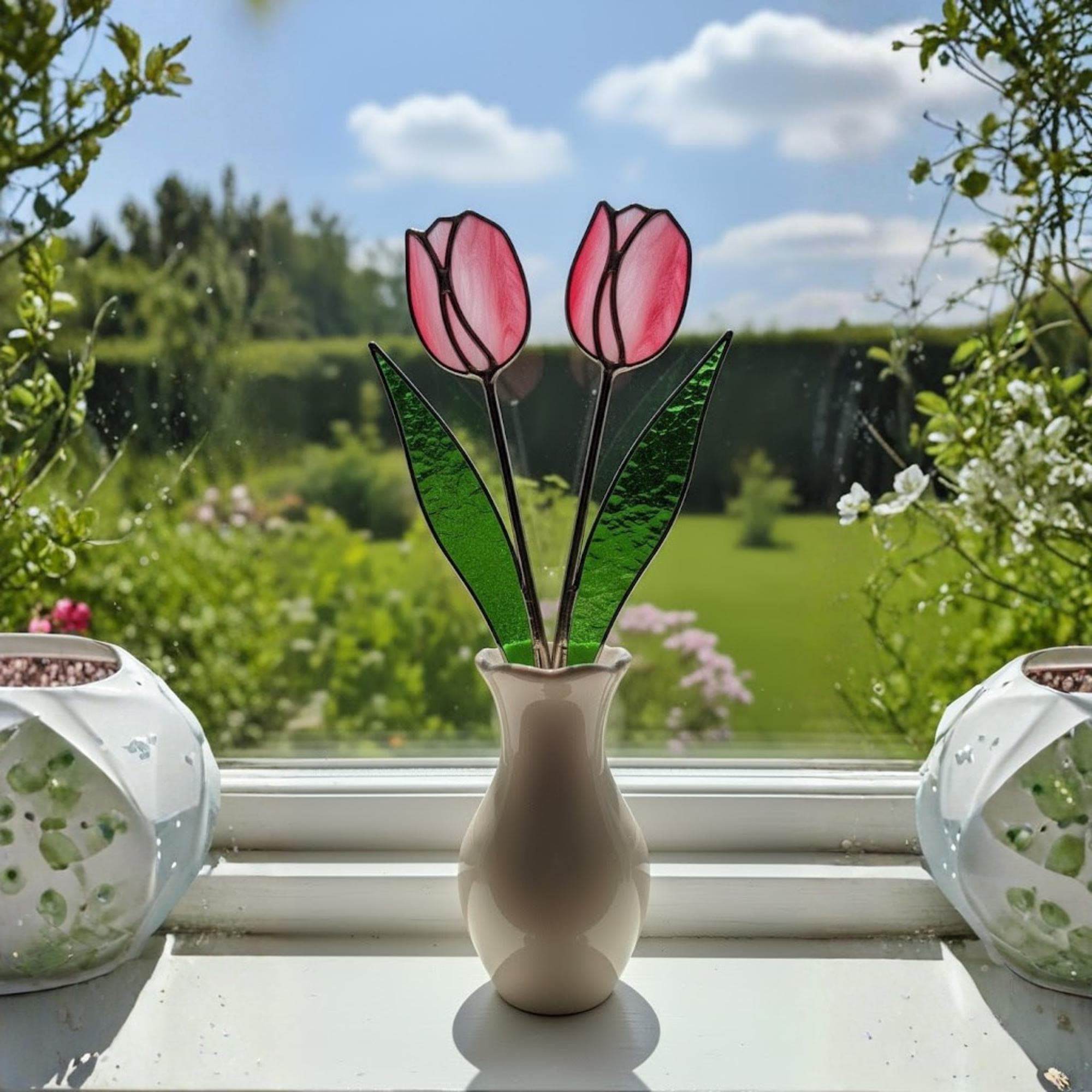 Two stained glass tulips in a vase glowing with morning light – simple elegant handmade decor.