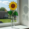 Handmade stained glass sunflower bouquet displayed in natural window light.