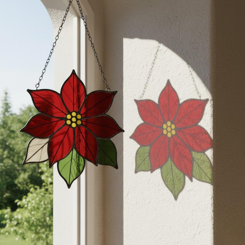 Bright red stained glass poinsettia hanging decor reflecting light beautifully.