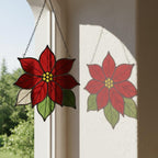 Bright red stained glass poinsettia hanging decor reflecting light beautifully.