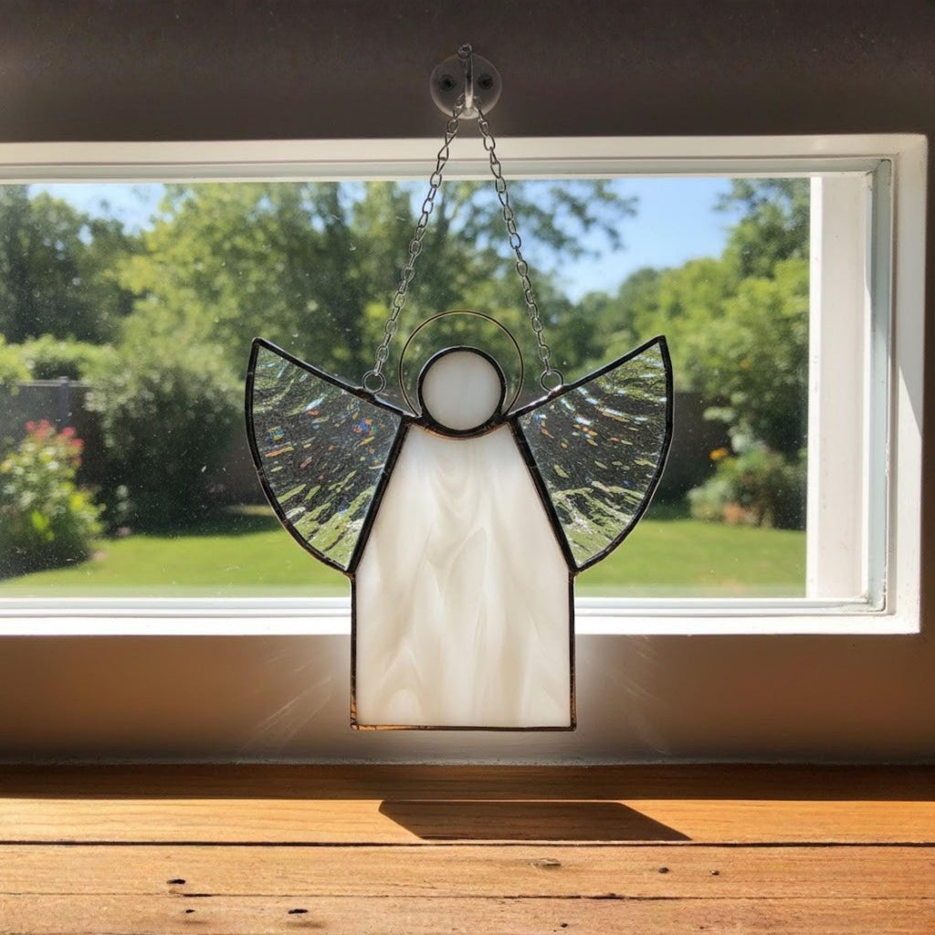 Handmade glass angel with textured clear wings in simple modern interior.