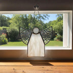 Handmade glass angel with textured clear wings in simple modern interior.