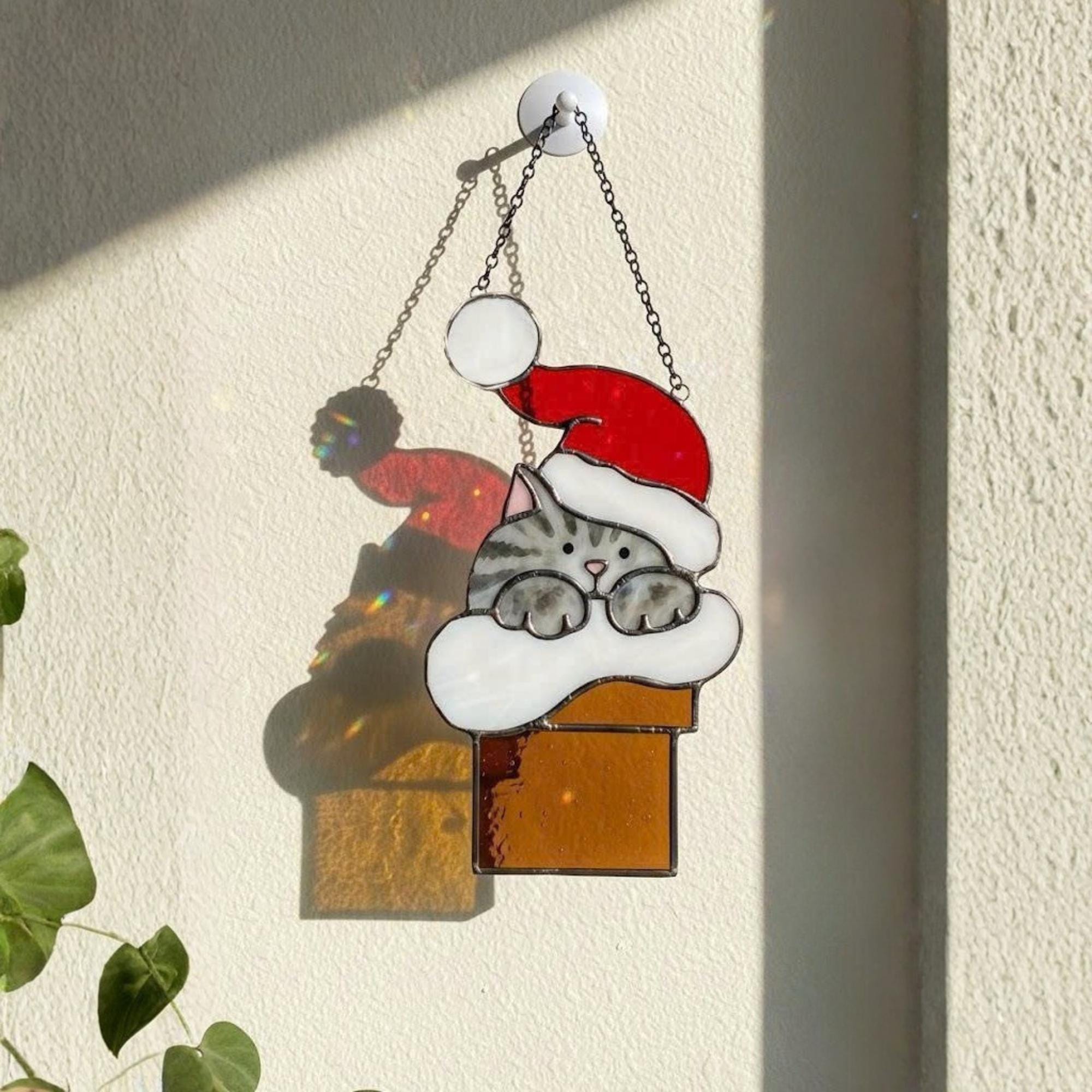 Handmade Christmas cat suncatcher stained glass ornament hanging on window, sunlight reflection holiday home decor gift for cat lovers
