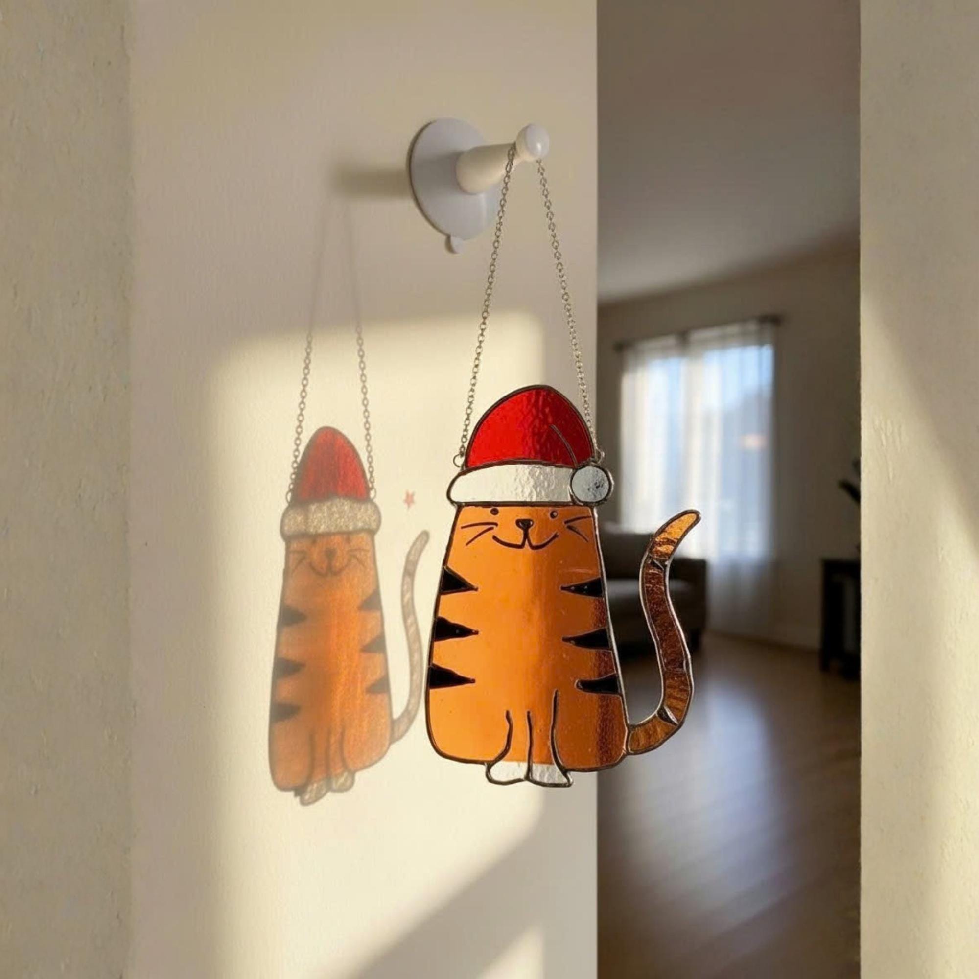 Stained glass Christmas cat suncatcher reflecting light on wall, handmade holiday decor perfect cat lover gift