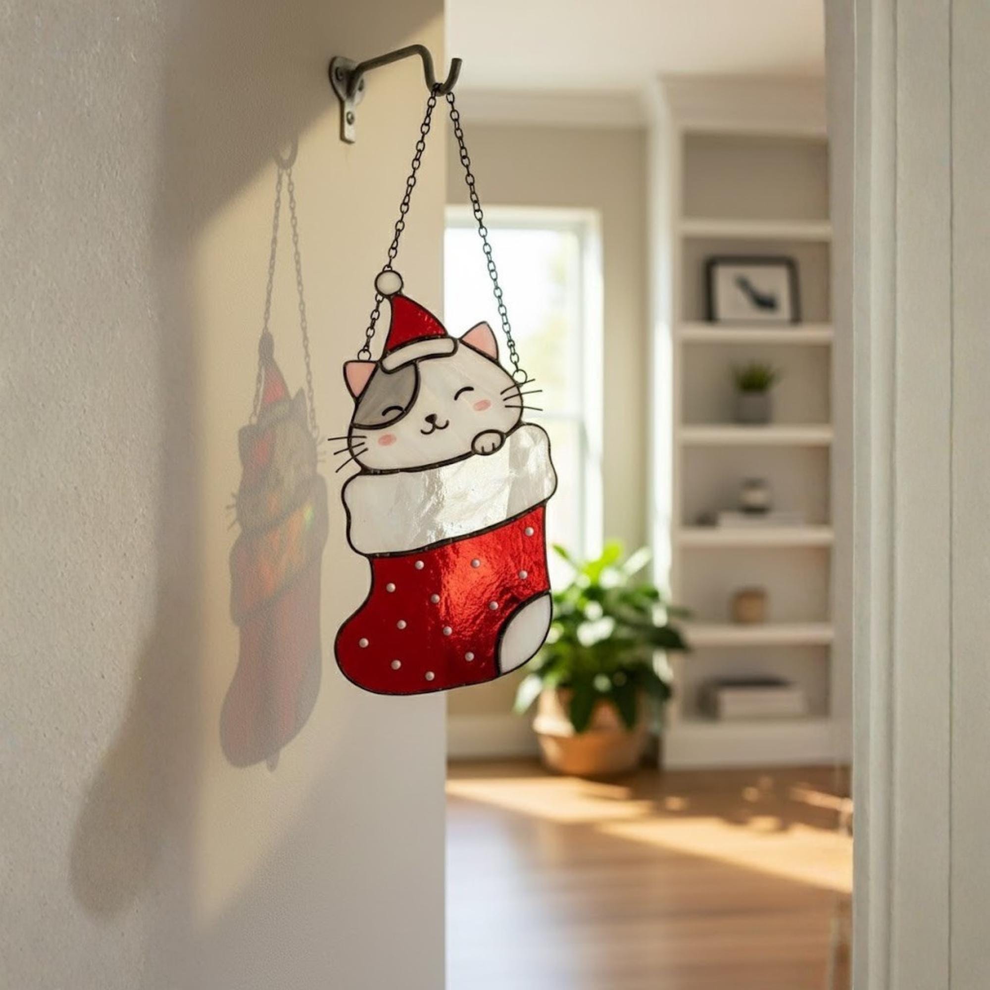 Set of four stained glass Christmas cats in stockings hanging on window, handmade holiday decor.