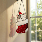 Window view with stained glass cats in stockings glowing in sunlight, festive home decoration.