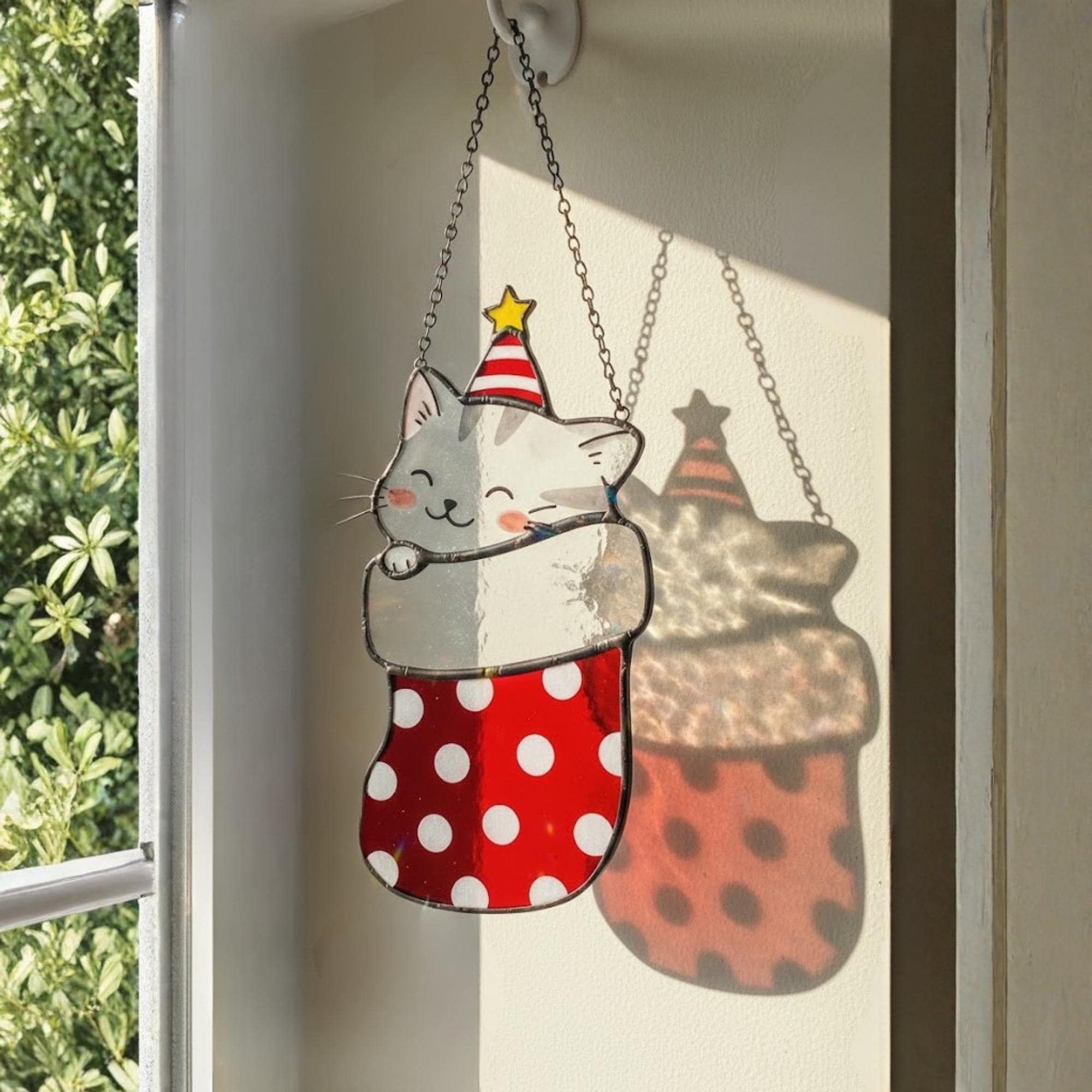Christmas cat stained glass suncatcher shining in sunlight, perfect handmade holiday decor.